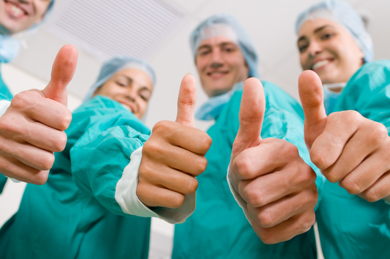 doctors with thumbs up